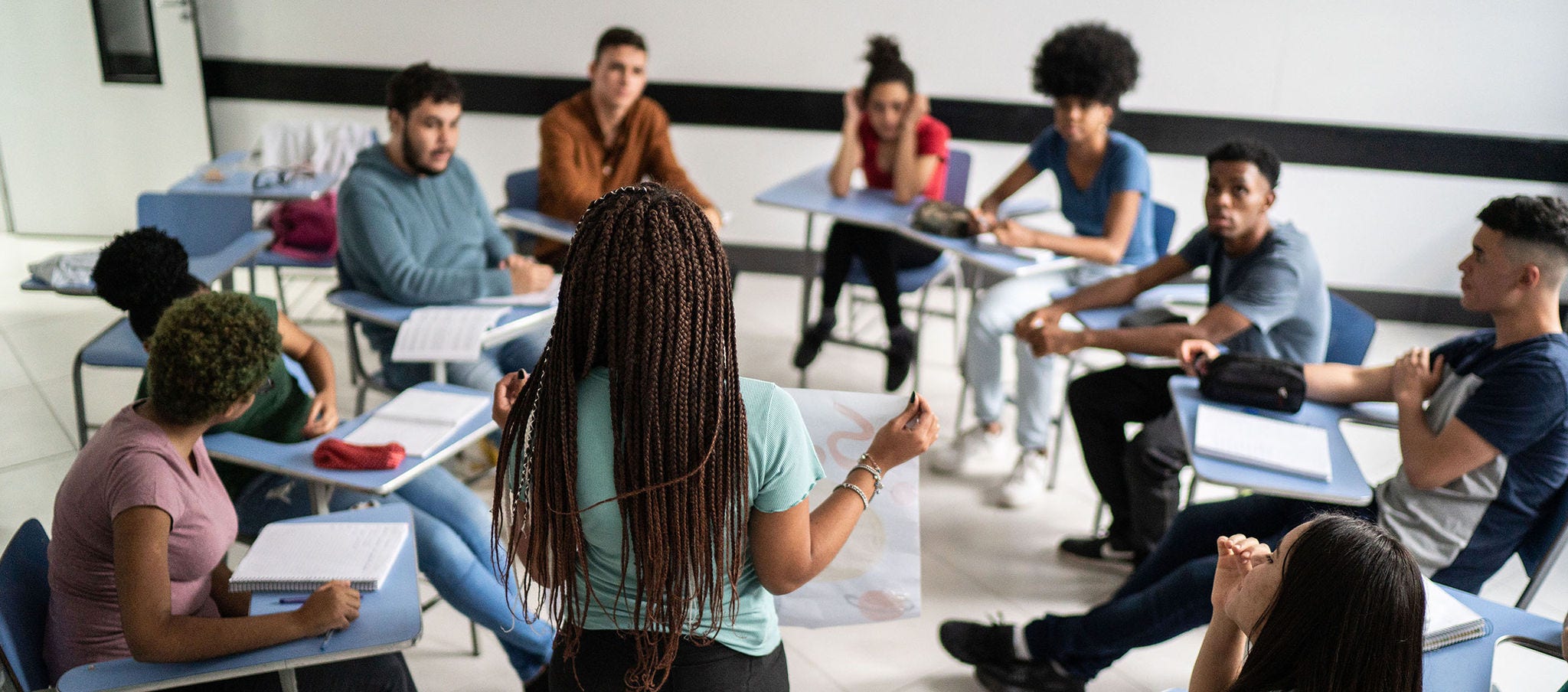 Woman presenting to class of students