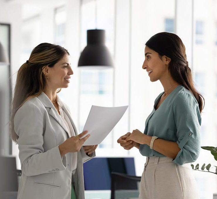 Two women talking in office