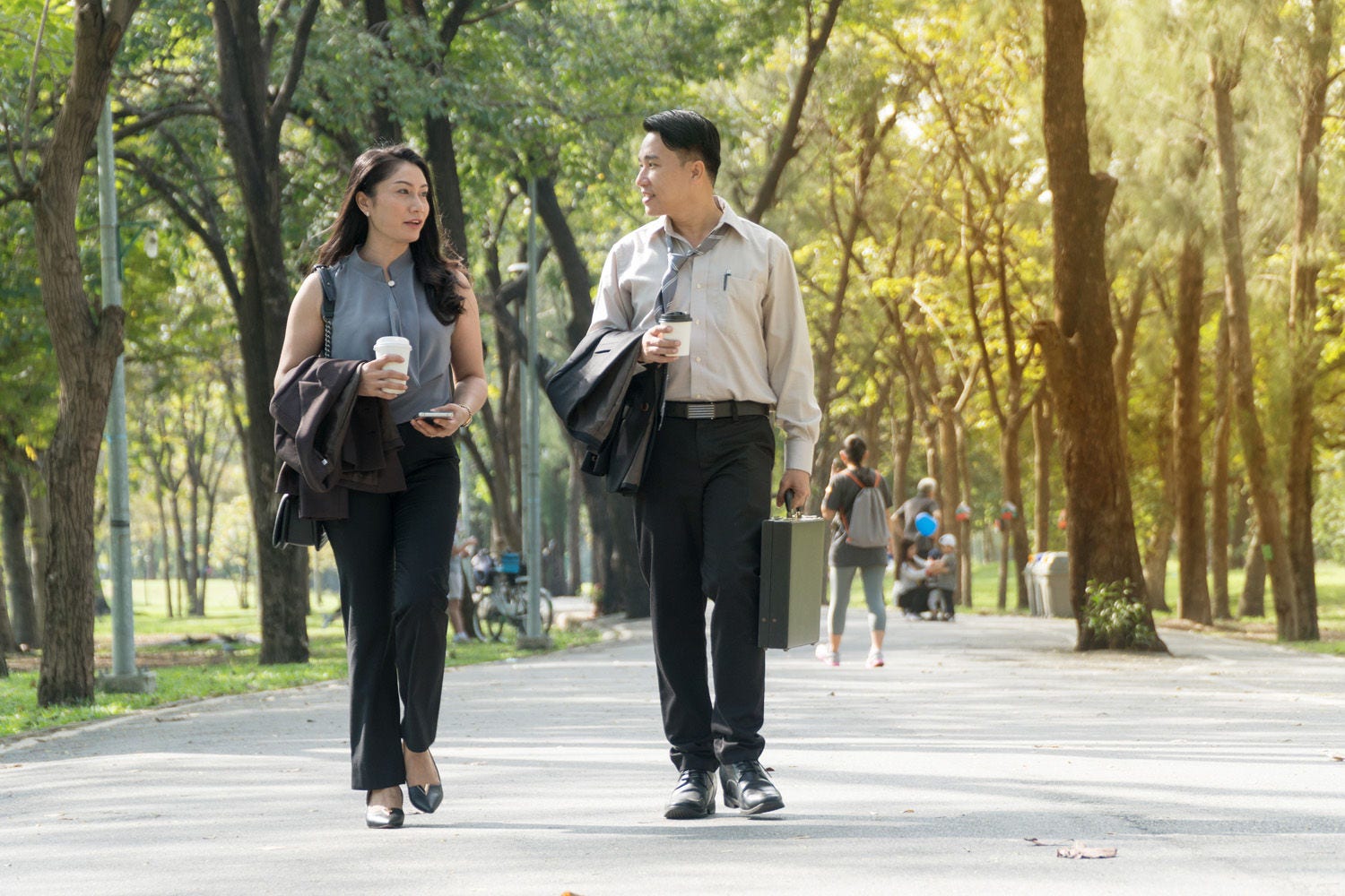 Man and woman walkng in park
