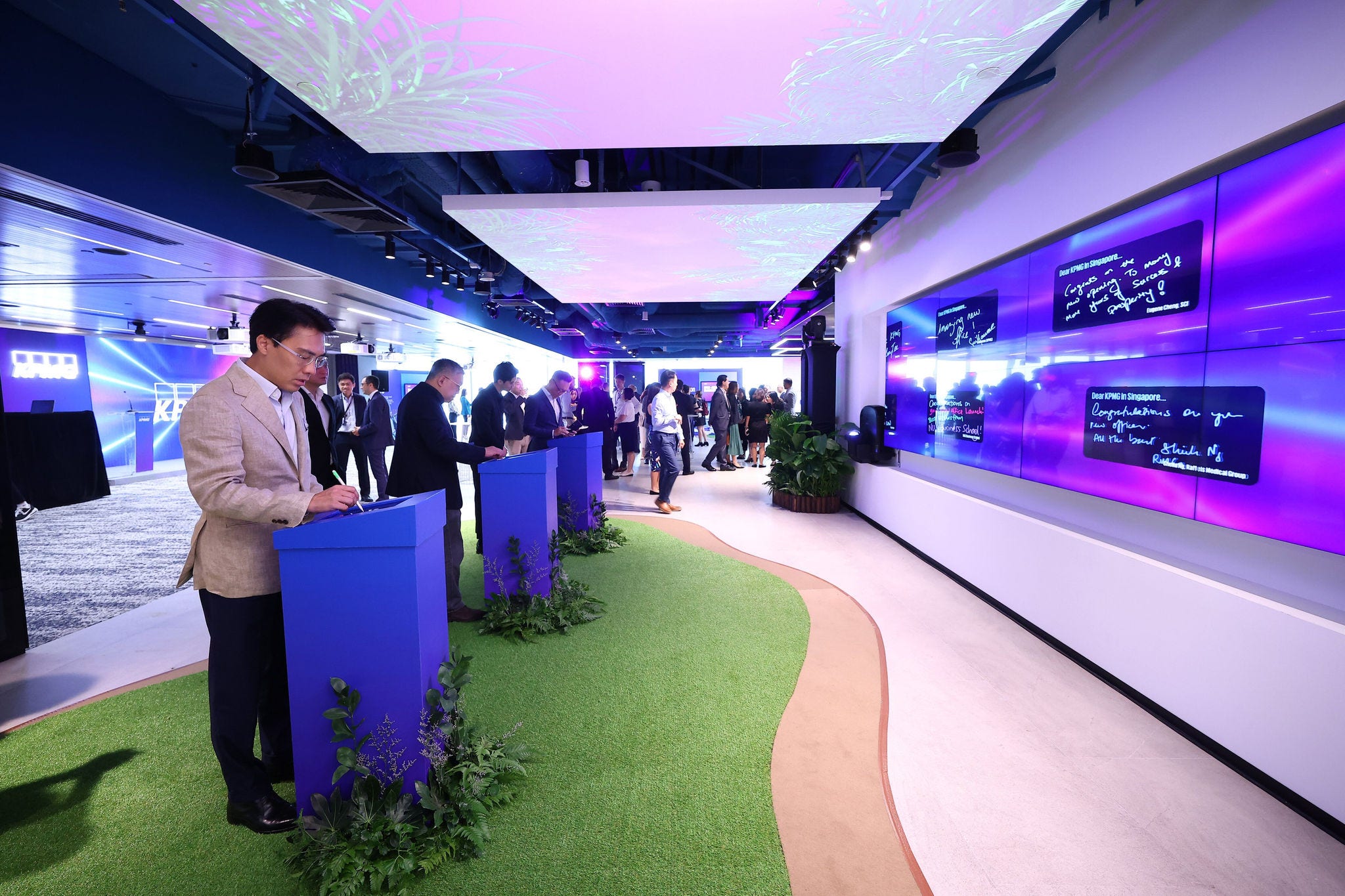 Guests interacting with panels at the official opening of KPMG in Singapore's office at Asia Square