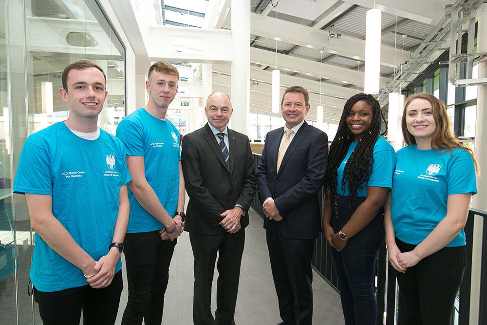 KPMG Managing Partner Seamus Hand and UCD President Professor Andrew Deeks pictured with students at the launch of the KPMG Skills Zone at the opening of the new Moore Wing at the UCD Quinn School of Business.