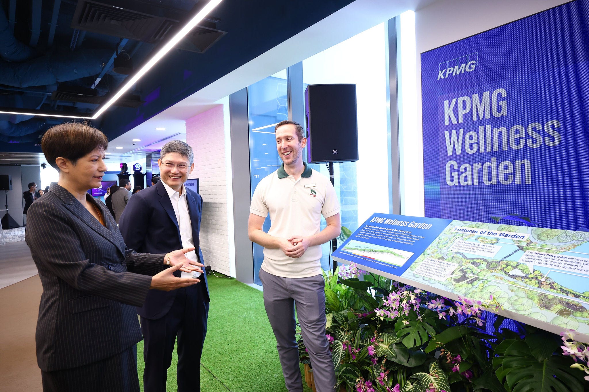 Guest of honour Minister Indranee Rajah and Managing Partner Ong Pang Thye speak with a representative from NParks at the official opening of KPMG in Singapore's office at Asia Square