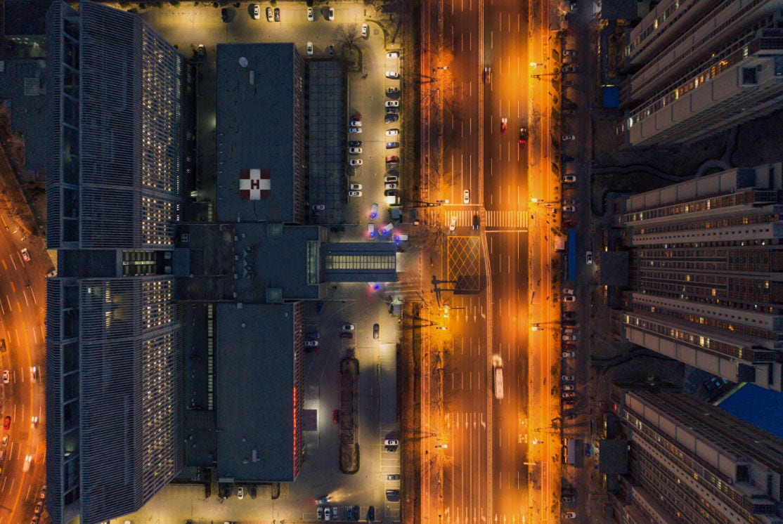 Overhead view of a hospital and ambulances in the driveway