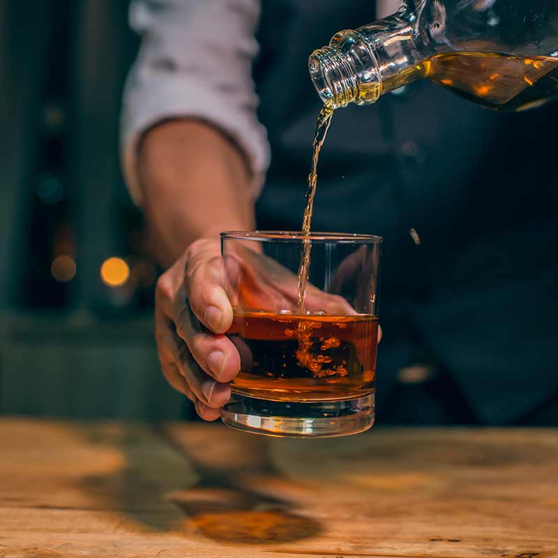 whiskey being poured into glass