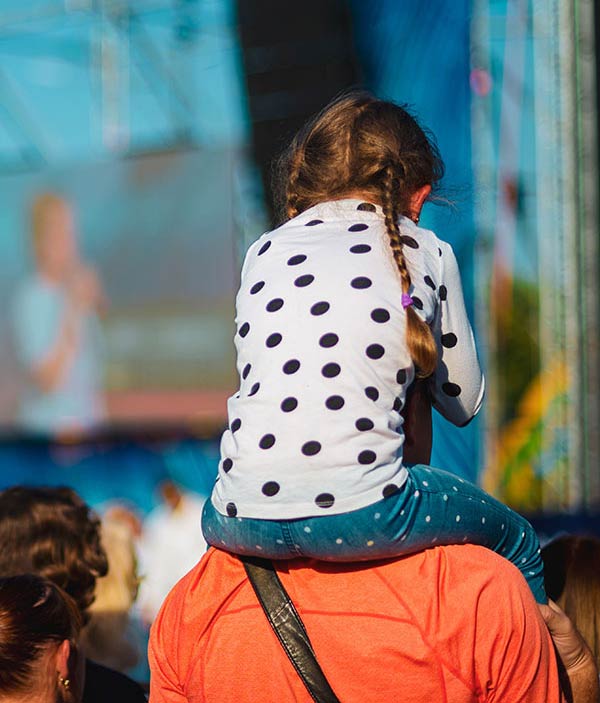 Child on parent's shoulders