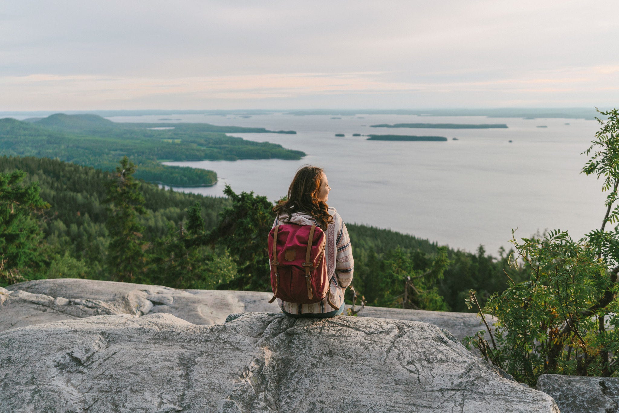 Scenic view of woman looking at  lake in Finland at sunset