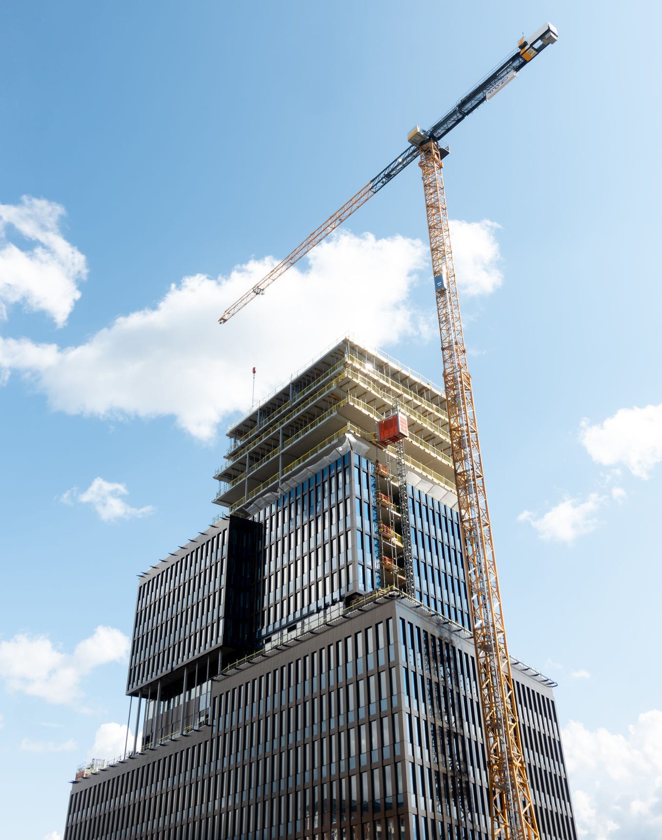 construction site of modern glass facade skyscraper