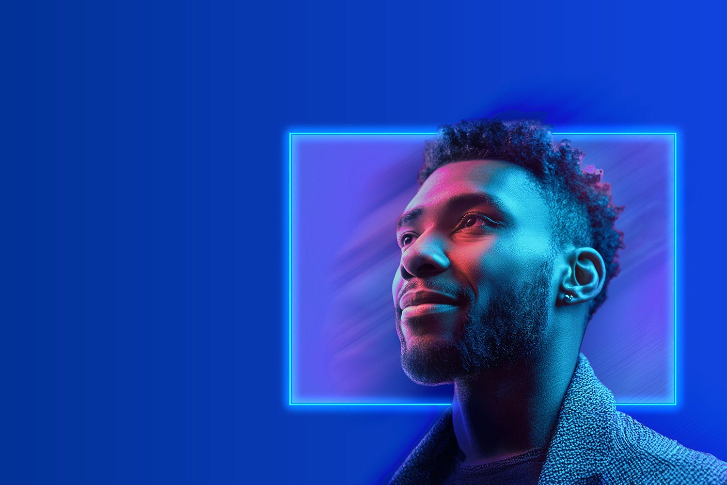 A person looking ahead with a blue rectangle behind them in the backdrop