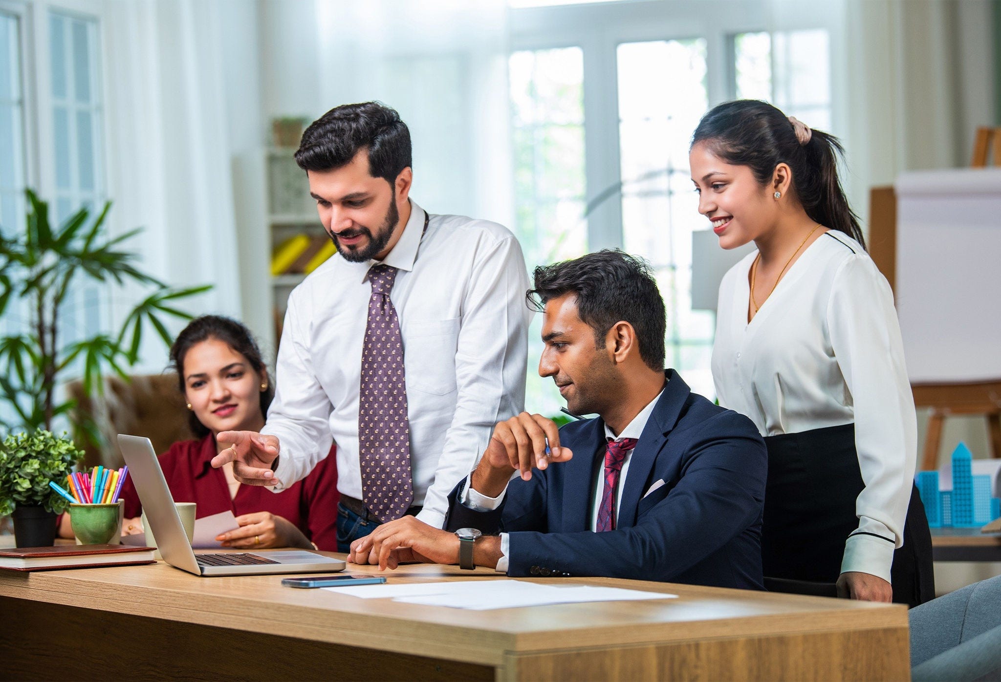 Cinematic Footage of a Successful Indian CEO Making a Presentation on a Laptop to a Board of Directors During a Corporate Meeting. South Asian Business Partners Discussing International Markets