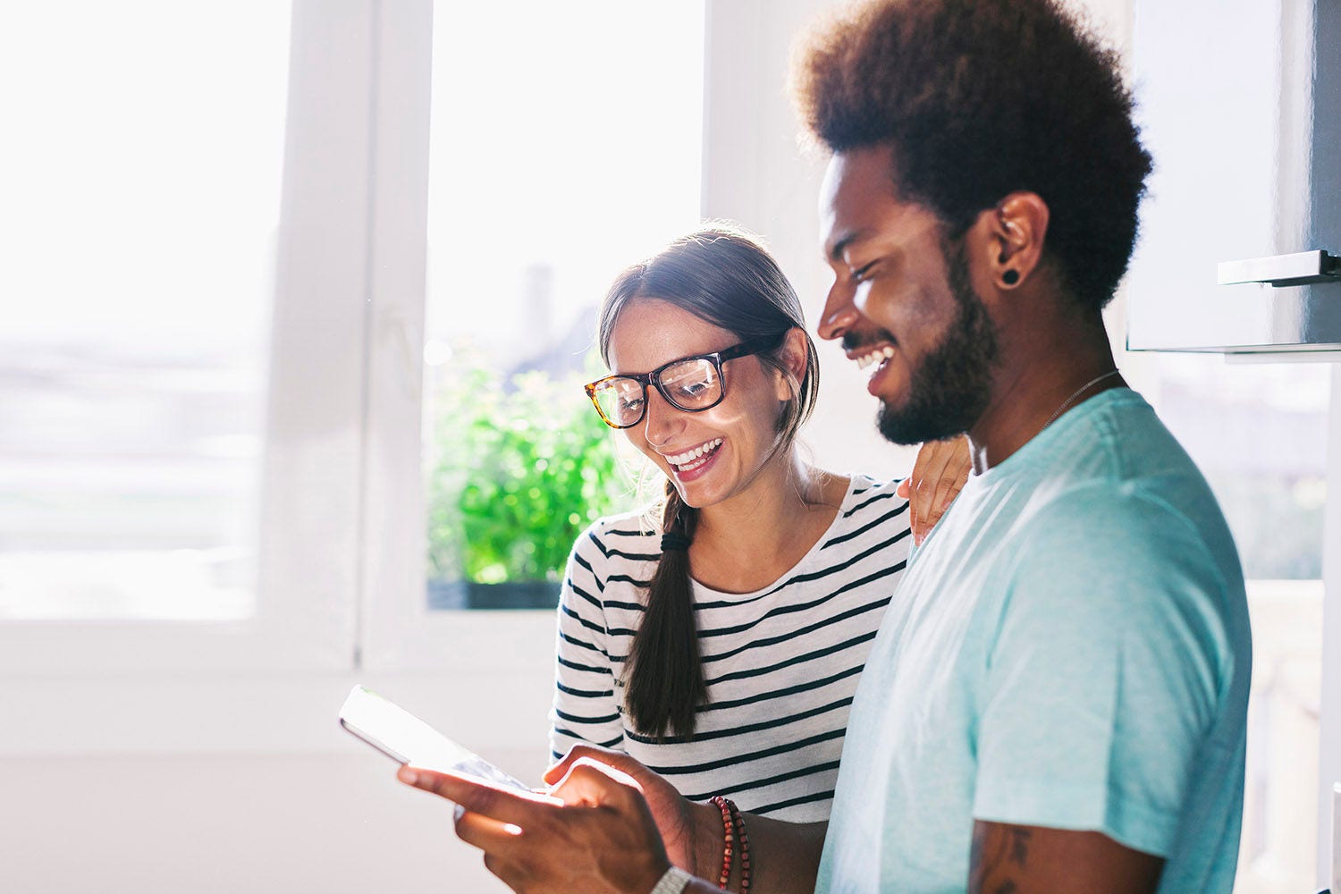 Thrive with us man and woman laughing using tablet