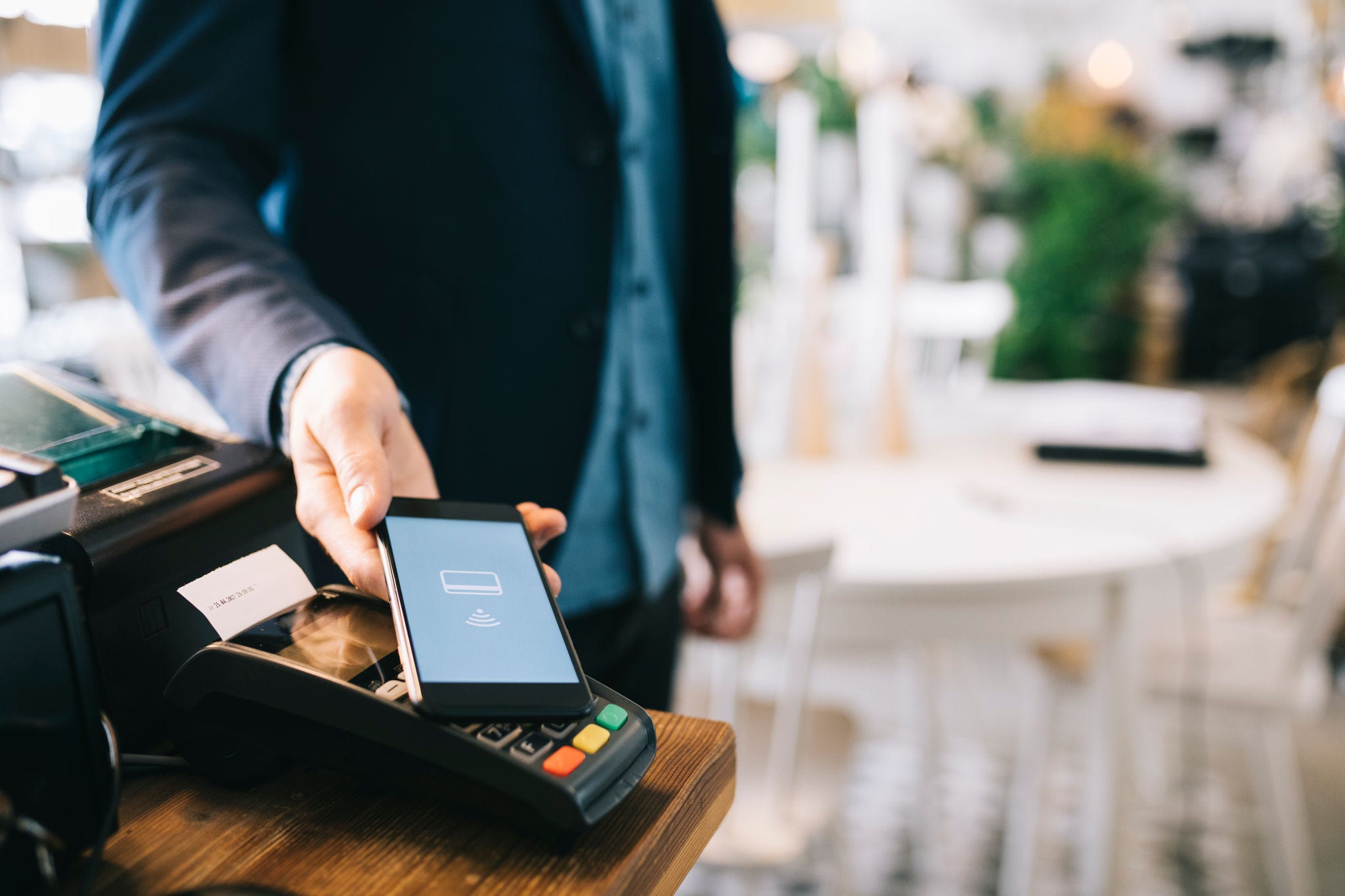 Man paying with smartphone using NFC.