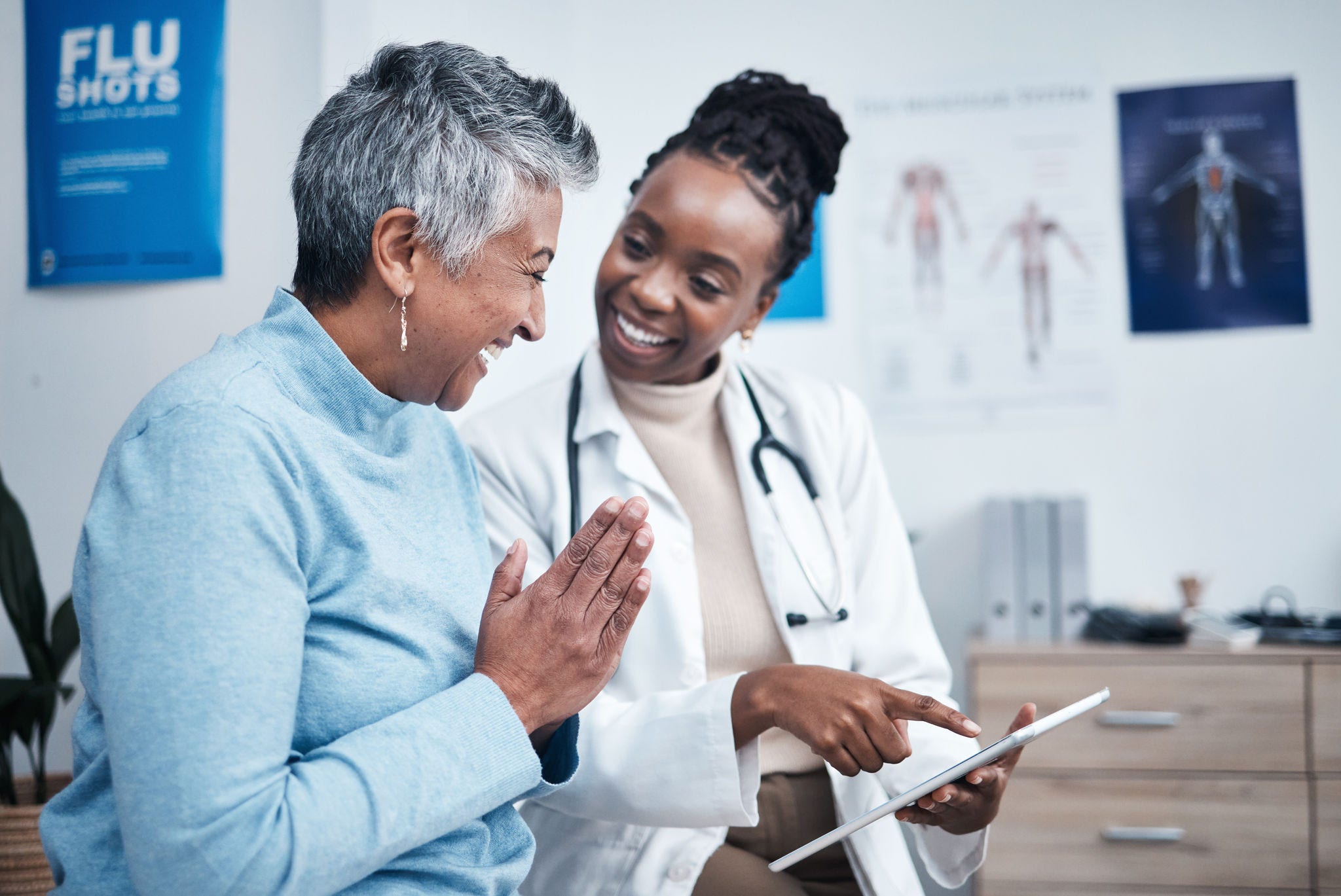Black woman, doctor and elderly patient with good news, tablet and results for health, advice and report. Happy african medic, mobile touchscreen or healthcare with smile, tech or support in hospital.