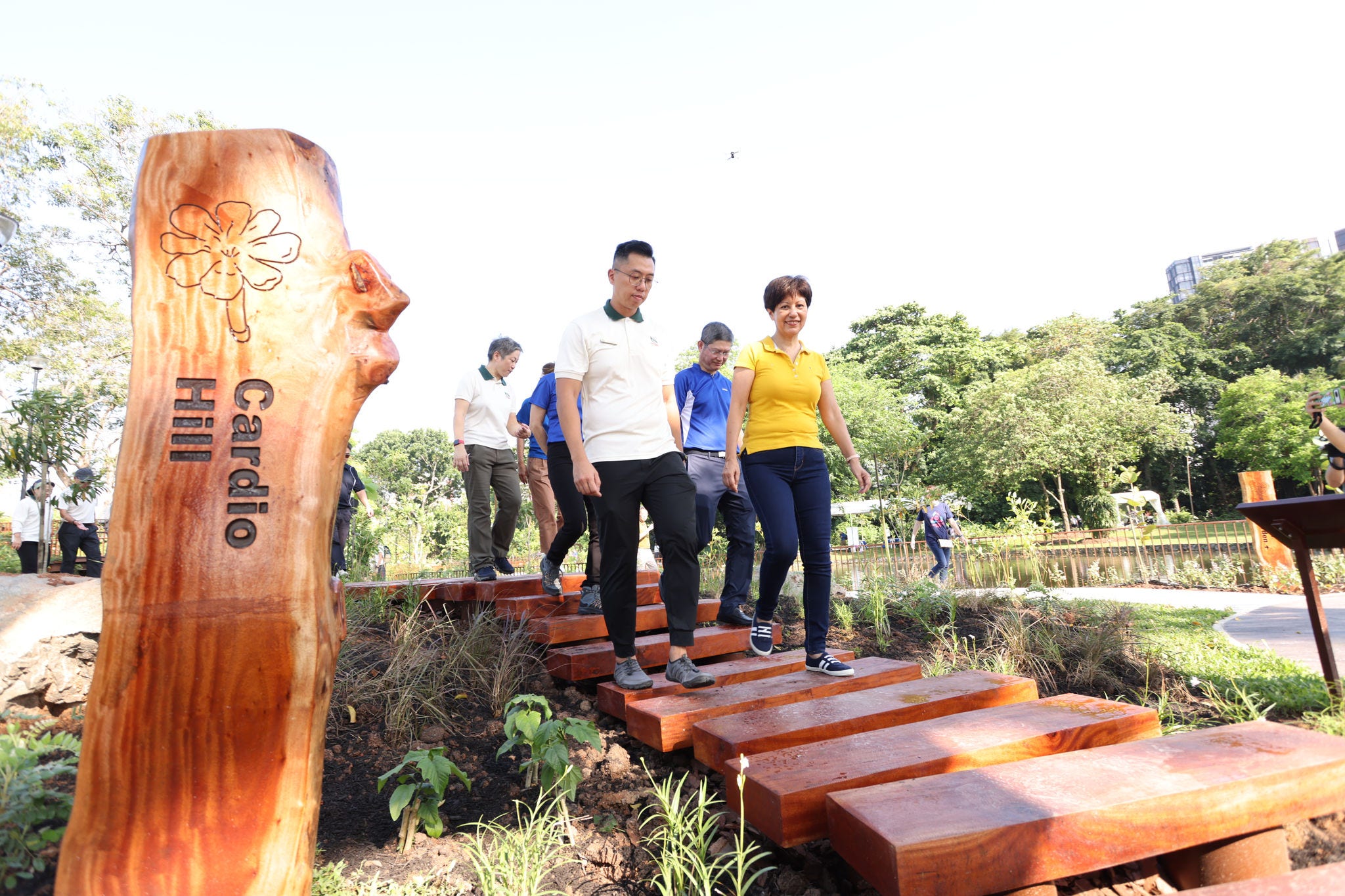 KPMG Managing Partner Ong Pang Thye, Minister Indranee Rajah, and NParks representatives walking on Cardio Hill at the KPMG Wellness Garden