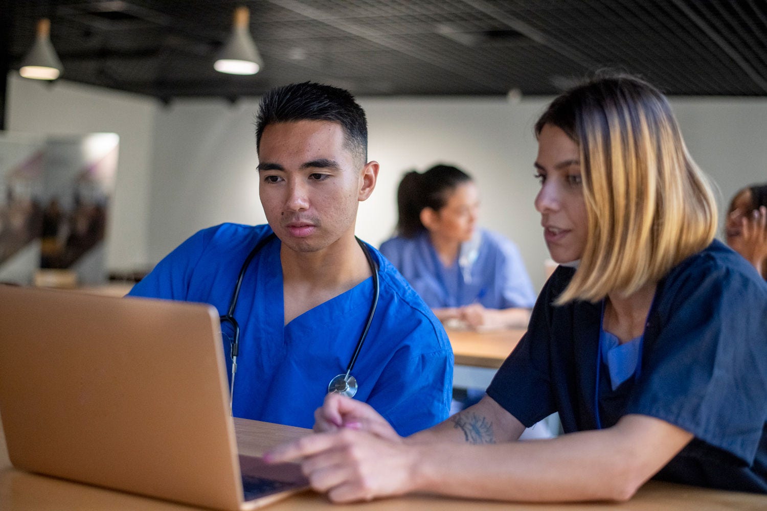 Two medical students work together on a team assignment