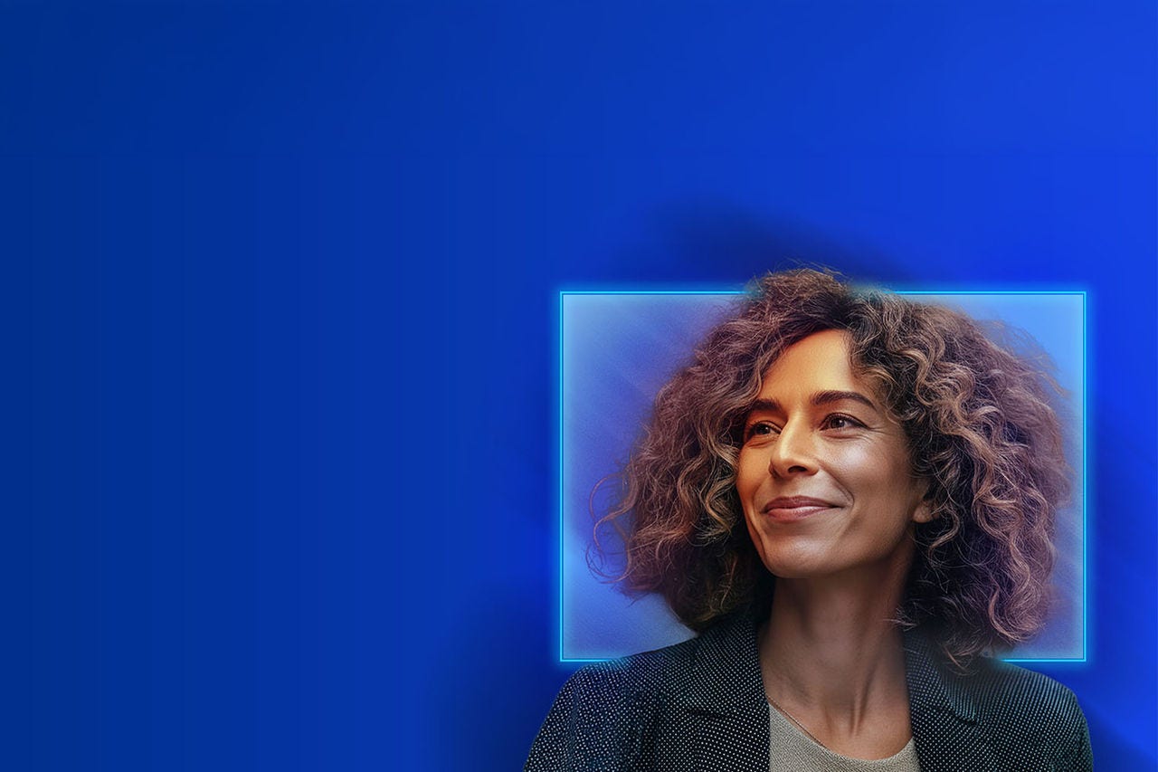 Portrait of a person with curly hair, set against a blue background with a glowing square frame around the head