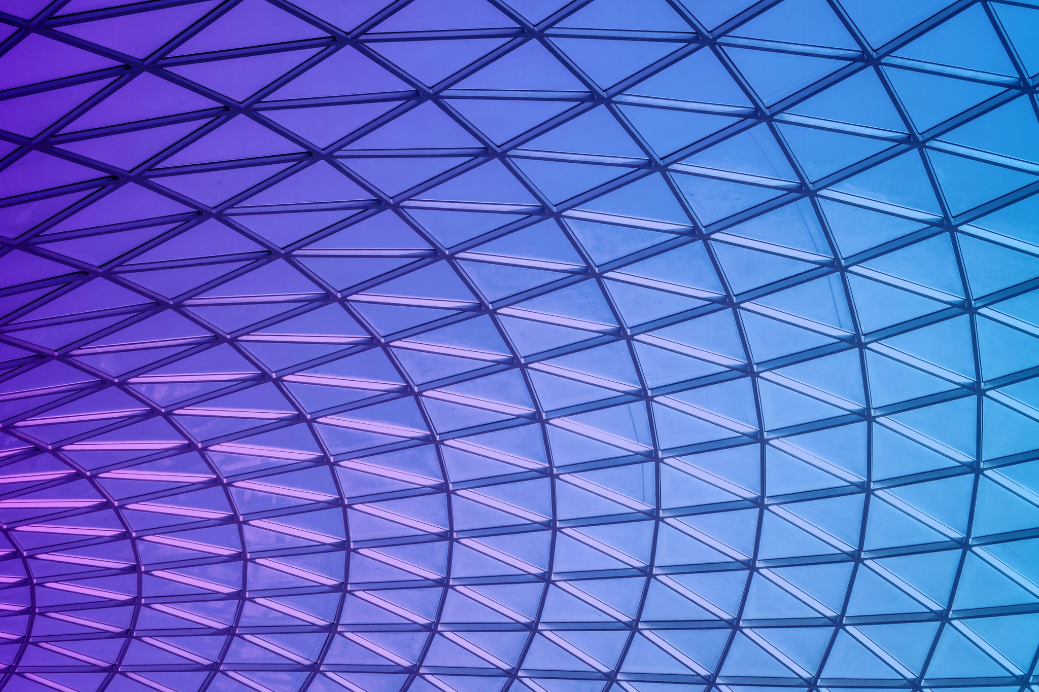 Glass panels forming geometrical shapes with a beautiful blue sky in the background