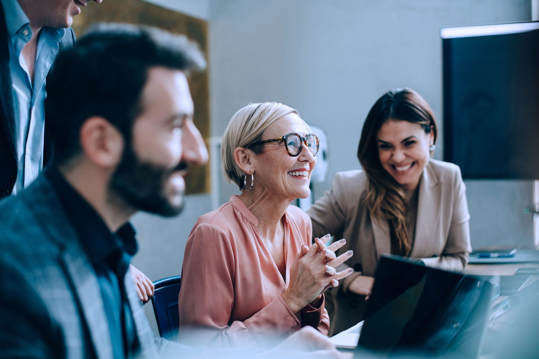 Smiling colleagues at a work meeting