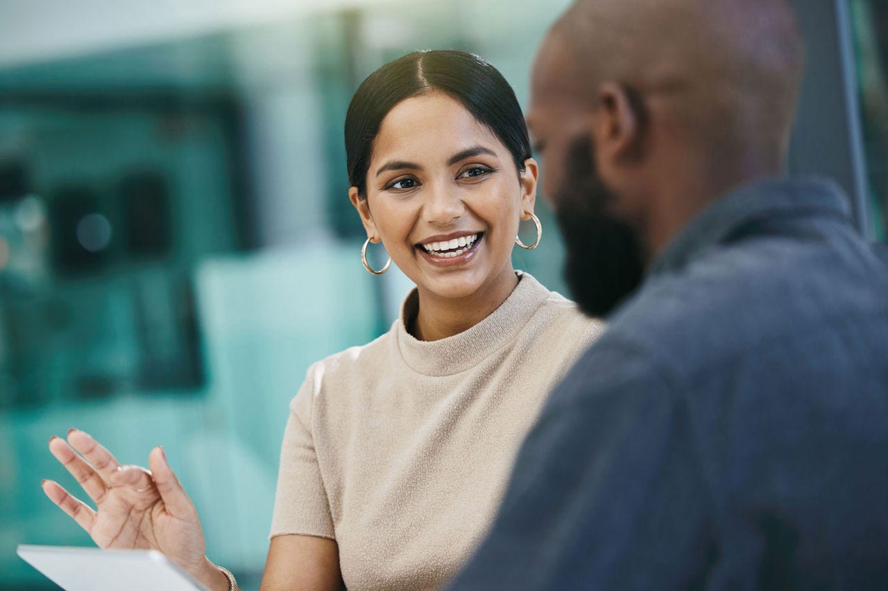 Two colleagues talking in an office environment