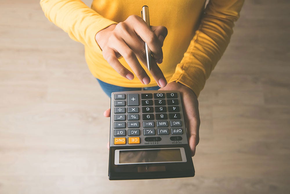 Hand using calculator