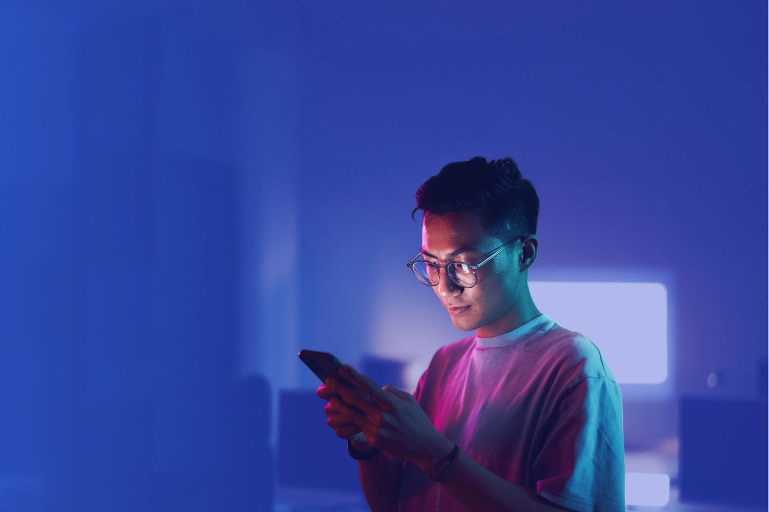 A person looking down at their mobile phone