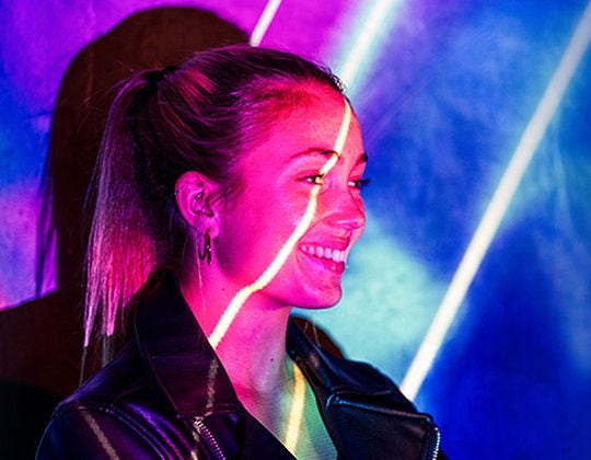 Smiling woman with a beam of light across her face