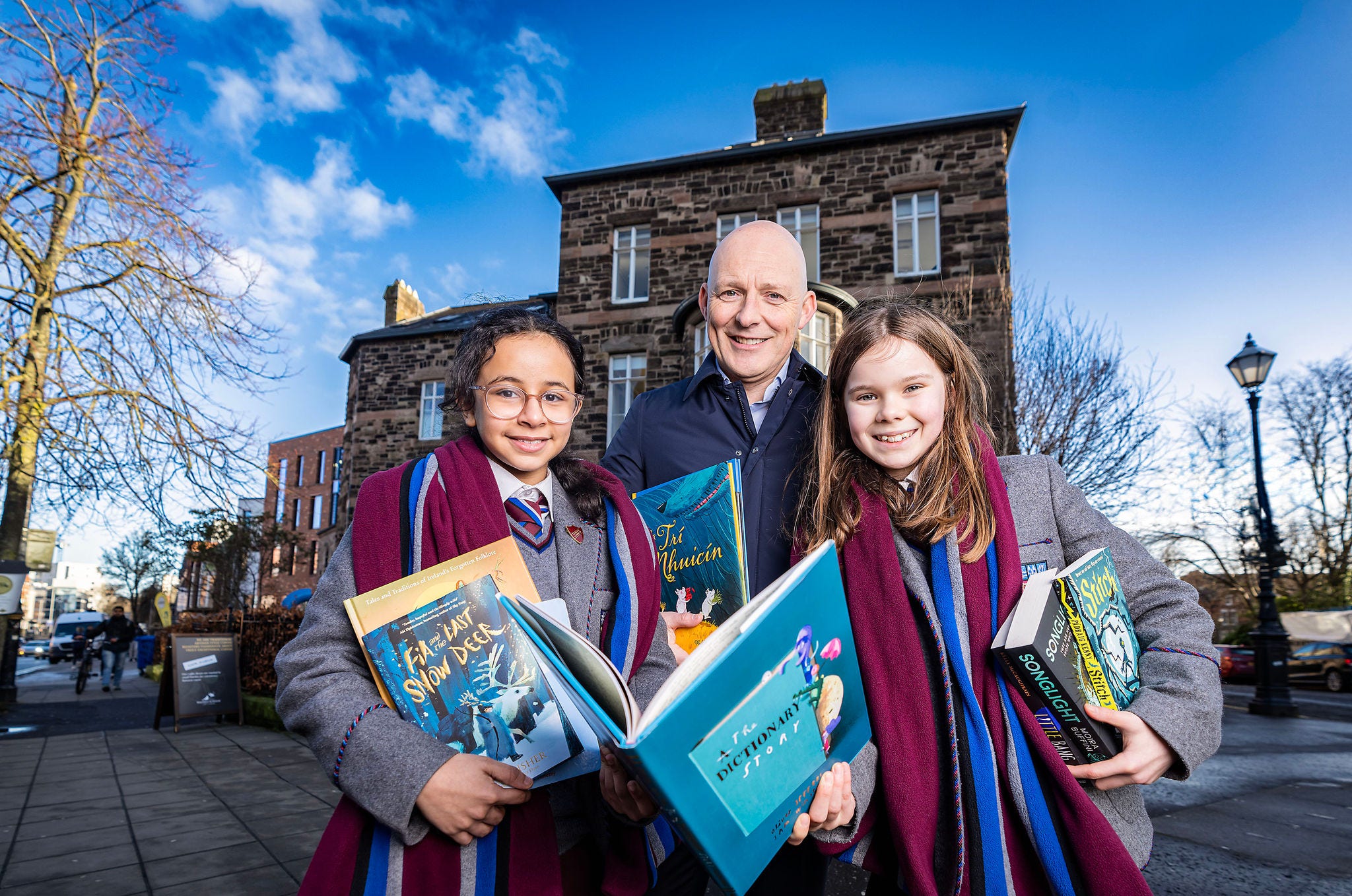 ‘Year 8 students Rosie Quinn and Haifa Alswailem from Victoria College with Johnny Hanna, Partner in Charge KPMG Belfast at the shortlist announcement of the KPMG Children’s Books Ireland Awards 2025 in Belfast’s Crescent Arts Centre.’