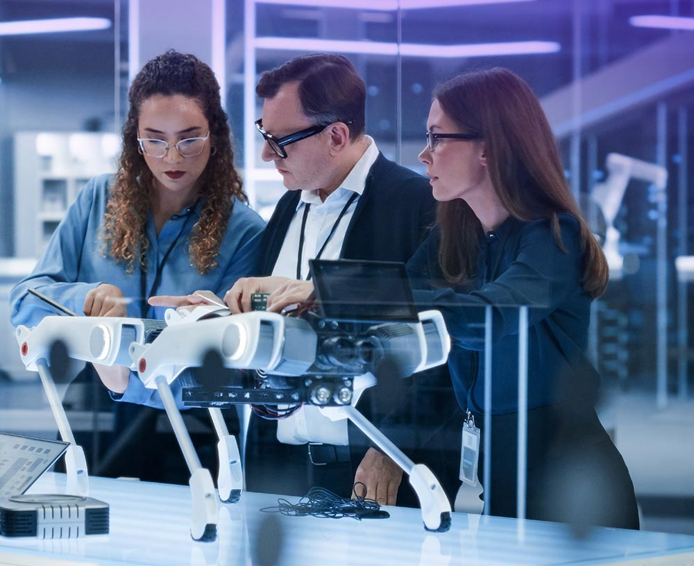 3 people working on robot