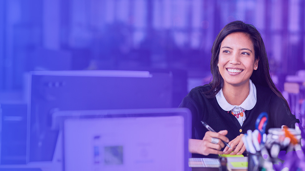 woman smiling at a desk