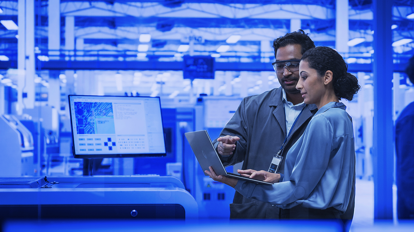 A person and person looking at a computer