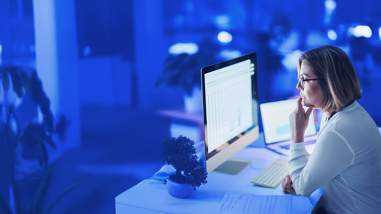 A person sitting at a desk with a computer