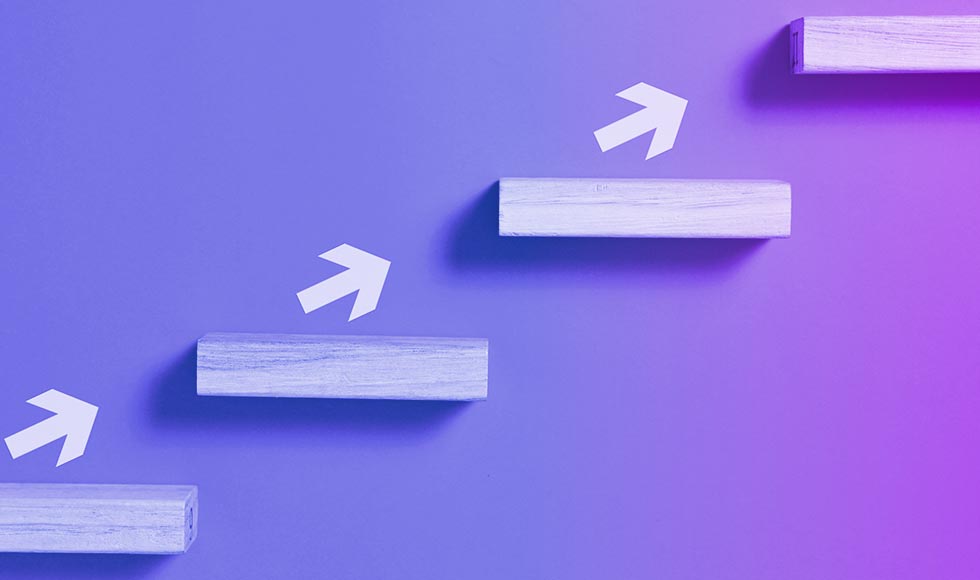 arrows pointing upwards along wall-mounted wooden steps